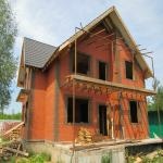 Design of a country wooden house with brick facing